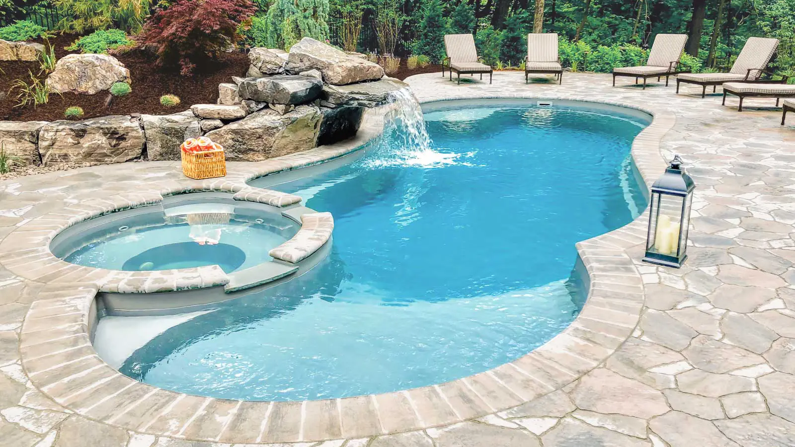 Leisure-Pools-Allure-fiberglass-pool The Allure, a freeform fiberglass pool with a built-in spa in addition to a splash pad