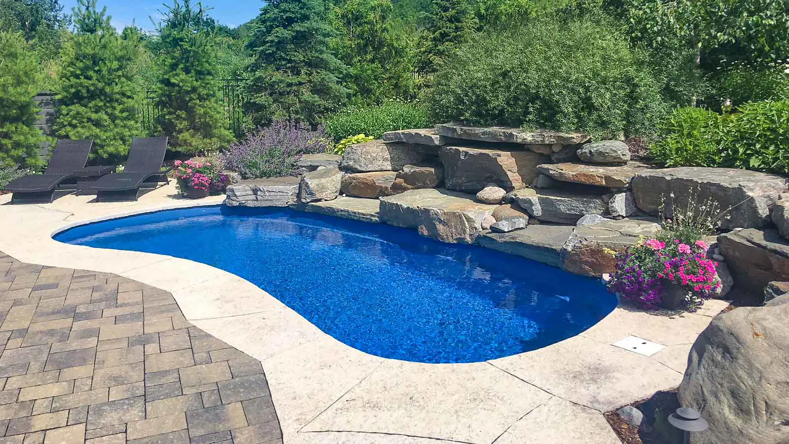 Leisure Pools Limitless rectangular fiberglass swimming pool with built-in spa and splash deck